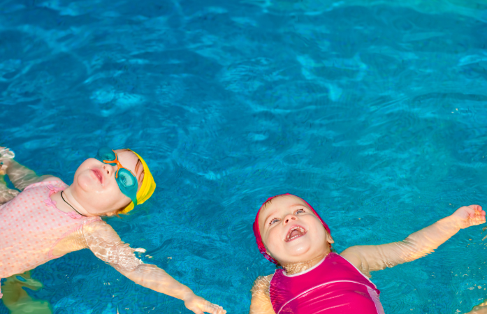  two children in the pool floating